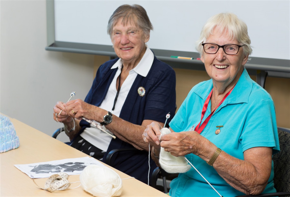 Picture of two women knitting. 