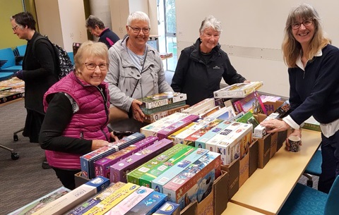 Picture of people attending the Jigsaw Puzzle Exhange at Whangārei Central Library in August 2023. 