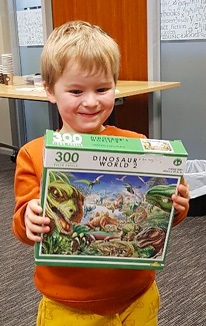 Young boy with his puzzle at the Jigsaw Puzzle Exhange at Whangārei Central Library on 20 August 2023.