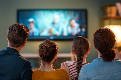 Family watching a movie on their TV.