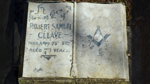 Photograph of an old grave stone with a Freemason symbol - a compass and square ruler.