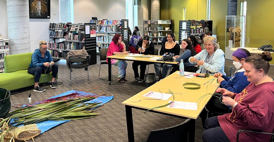 Picture of people taking part in an Introduction to Flax Weaving Workshop during Te Wiki of Te Reo Māori, September 2022. 