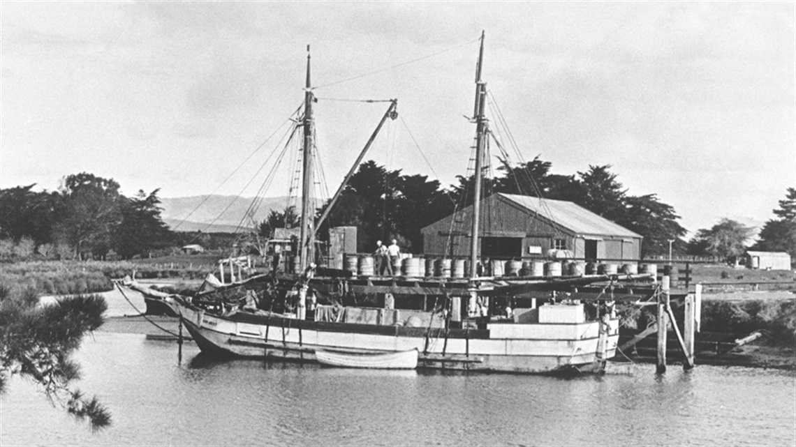 The scow Nor'west loading fuel at the Upper Wharf, Waipū River in 1939. Waipū Scottish Migration Museum. 