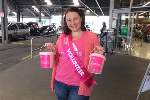 Photo of a woman holding Pink Ribbon Appeal collection buckets.   