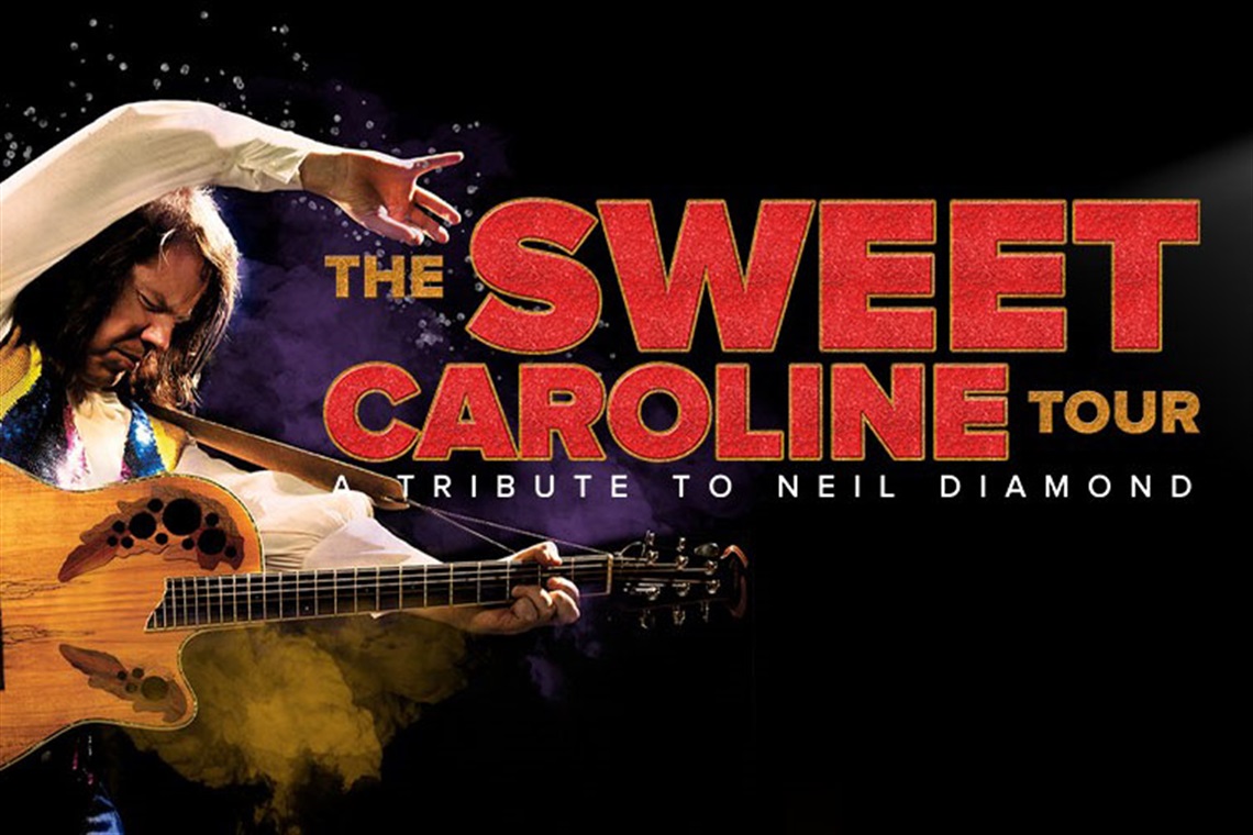A promo image of a Neil Diamond lookalike playing the guitar.