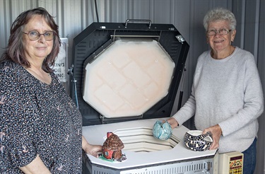 Bream Bay Combined Arts Group members celebrate their new kiln, made possible through community funding. 