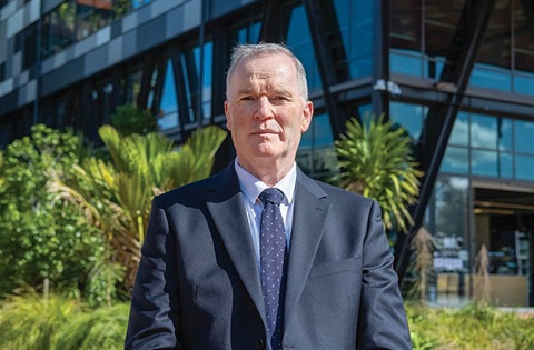 Mayor Ken Couper standing alone in front of Te Iwitahi (civic centre) on Rust Avenue, Whangārei. 