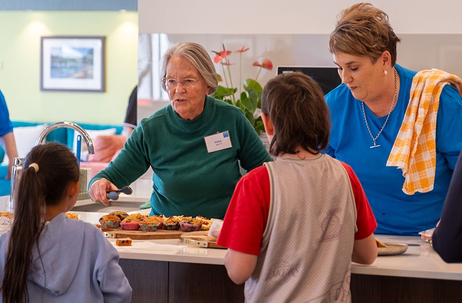 Women volunteers serving food to some children 
