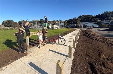A group of kids at the Whale Tail Park playground alongside the Kopipi Crescent footpath.