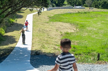 A child watches other children skating at the Parua Bay Skatepark. 