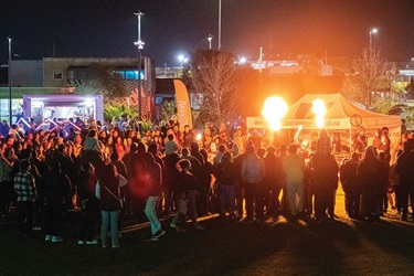 A crowd gathers outside for a Puanga Matariki Festival event. 