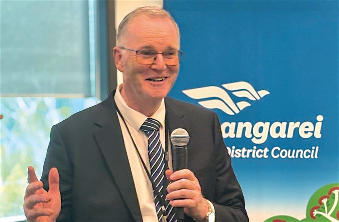Mayor Ken Couper speaking into a microphone at the Look North presentation at Te Iwitahi (civic centre). 