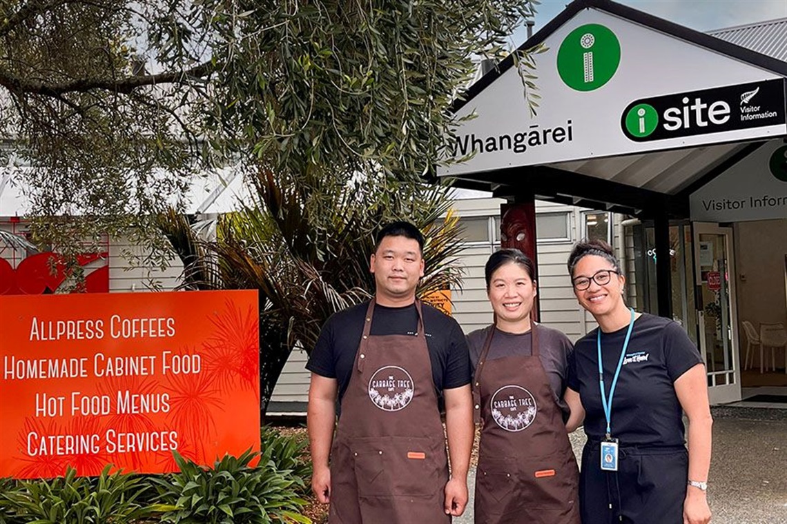 Owners Henry Wu and Anna Xu with isite Team Leader Reana Te Hei in front of the isite Information Centre. 