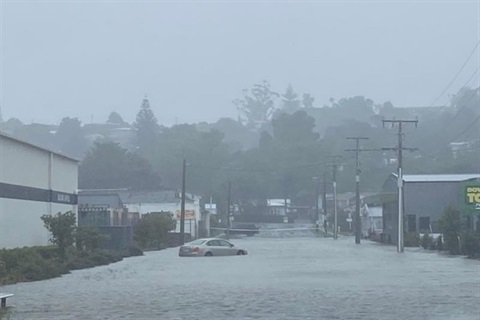 A photo of a car trapped in flood waters on a street in Morningside. 