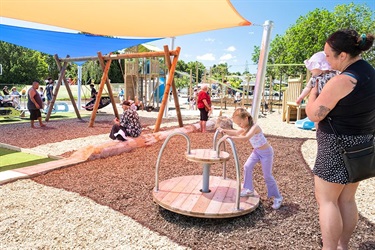 A mother watches as her daughter plays at Raumanga Scenic Reserve Playground.