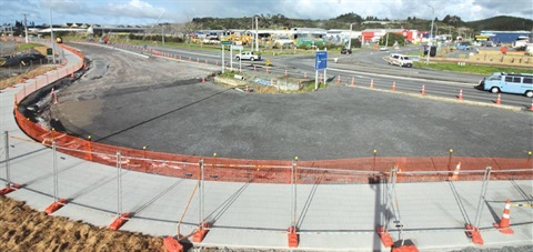 Construction of the roundabout at Port Road and Kioreroa Road with cars in the background. 