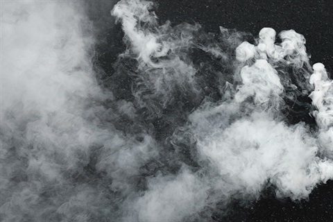Photo of smoke against a black backdrop. 