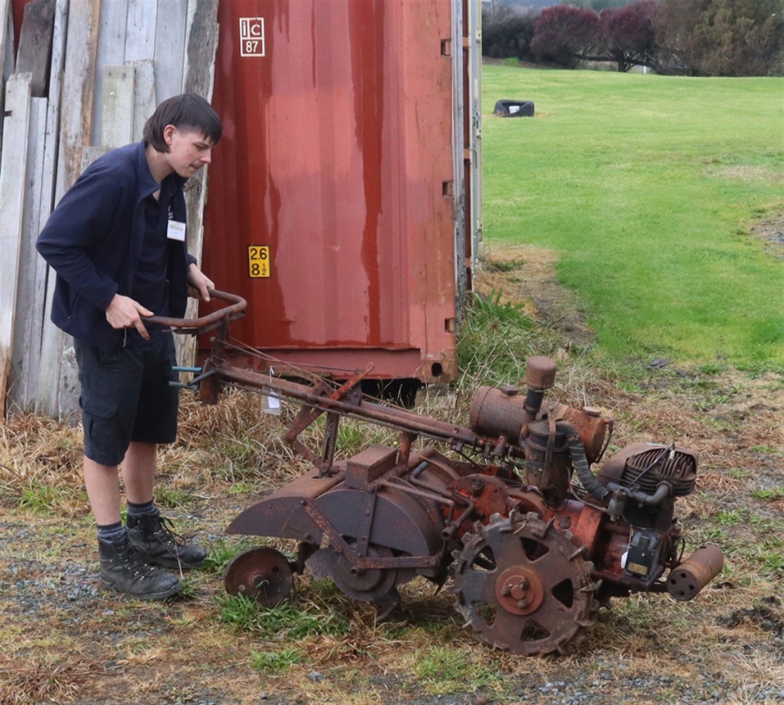 Image of young man with a Rotovator. 