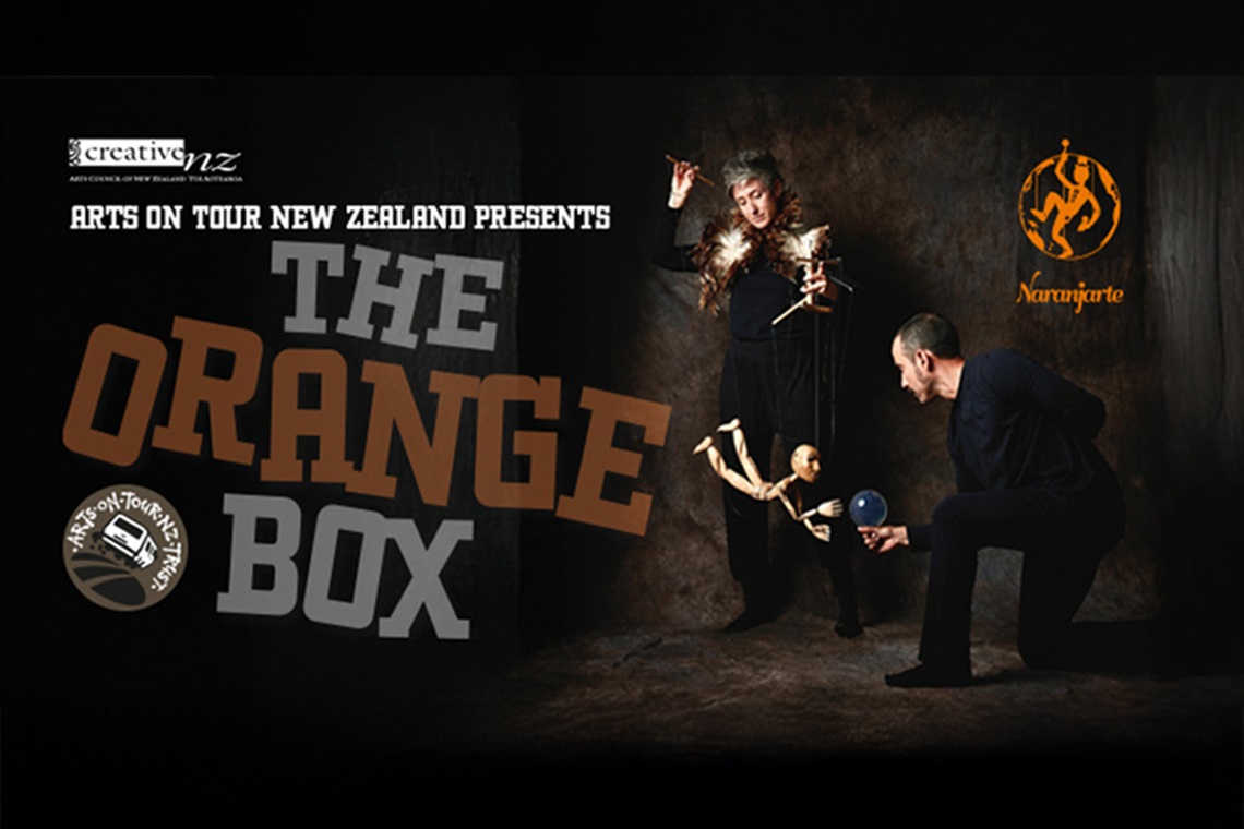 Promotional poster for 'The Orange Box' presented by Arts on Tour New Zealand. It features two performers—one holding a puppet and the other holding a blue ball. The poster includes logos for 'creative nz' (Arts Council of New Zealand Toi Aotearoa), 'Arts on Tour NZ,' and 'Naranjarte' with stylized figures. The title 'THE ORANGE BOX' is prominently displayed. 