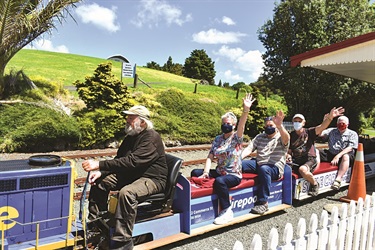 Older adults enjoying a miniature train ride at Kiwi North.
