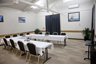 Bounty Room boardroom layout, corner room shot with chairs and tables setup.