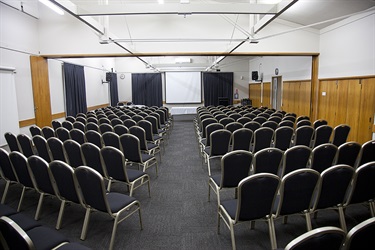 Cafler Suite theatre setup with many chairs setup, middle row view.