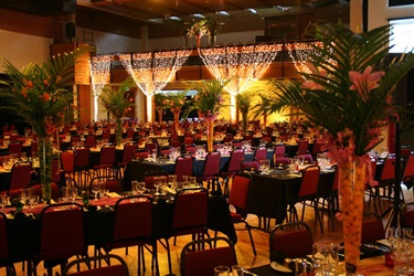 Photo of the Exhibition Hall set up in the banquet layout with tables and lighting.