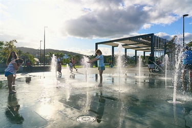 Kids playing with water feature during day time